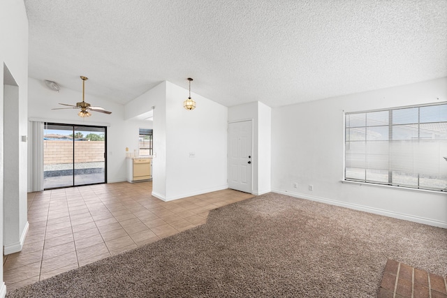 37756 E 45th St, Palmdale, CA 93552 - unfurnished living room featuring light tile patterned floors, a ceiling fan, a textured ceiling, light colored carpet, and baseboards