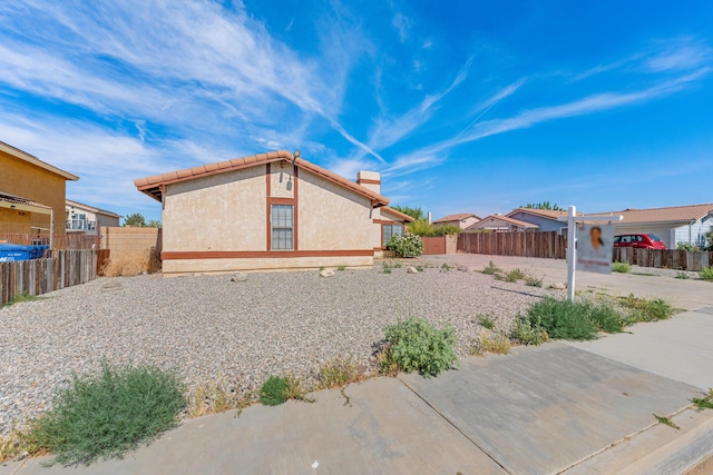 37756 E 45th St, Palmdale, CA 93552 - view of home's exterior featuring stucco siding and a chimney