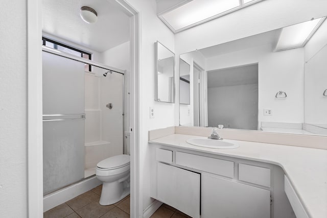 37756 E 45th St, Palmdale, CA 93552 - bathroom featuring a shower stall, tile patterned flooring, toilet, and vanity