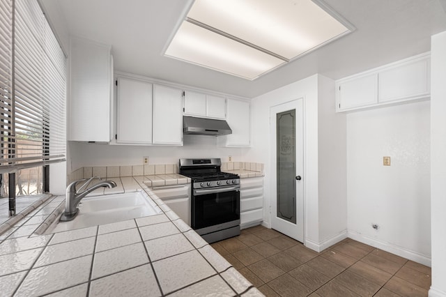 37756 E 45th St, Palmdale, CA 93552 - kitchen with gas stove, tile countertops, under cabinet range hood, white cabinets, and tile patterned floors