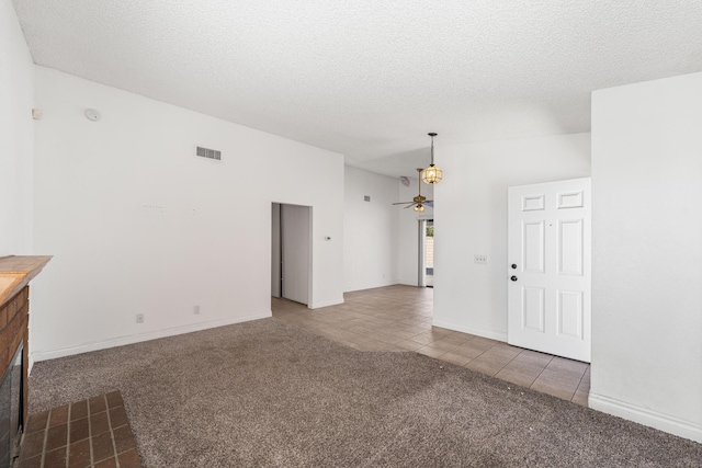 37756 E 45th St, Palmdale, CA 93552 - unfurnished living room featuring carpet, tile patterned flooring, a textured ceiling, ceiling fan, and baseboards
