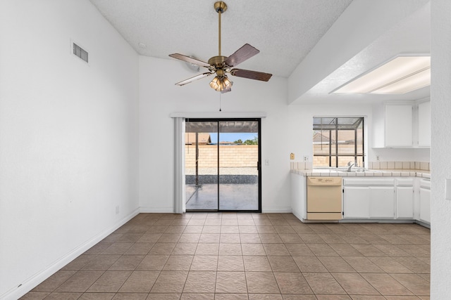 37756 E 45th St, Palmdale, CA 93552 - kitchen with dishwasher, a ceiling fan, plenty of natural light, white cabinetry, and a textured ceiling