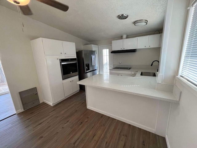 kitchen featuring sink, white cabinetry, appliances with stainless steel finishes, dark hardwood / wood-style flooring, and kitchen peninsula