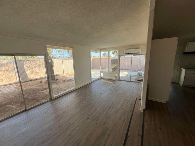 unfurnished sunroom with a wall mounted AC