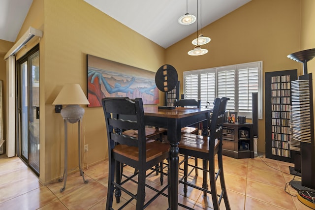 dining space featuring light tile patterned floors, a wealth of natural light, and high vaulted ceiling