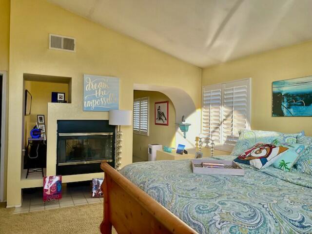 tiled bedroom with vaulted ceiling