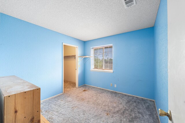 40968 E 174th St, Lancaster, CA 93535 - unfurnished bedroom featuring a textured ceiling, carpet, baseboards, a spacious closet, and visible vents