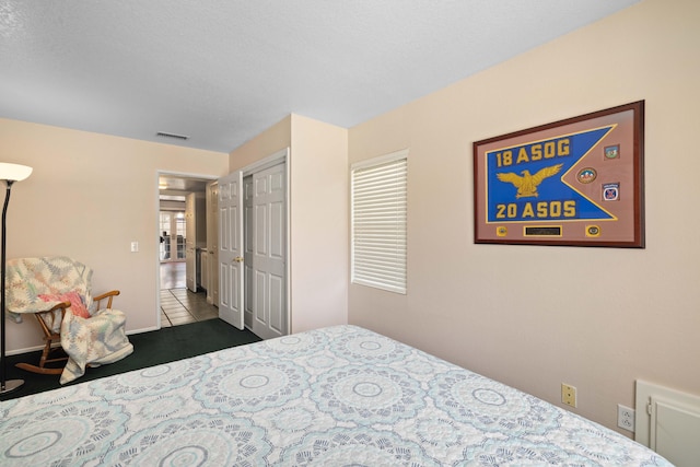 tiled bedroom featuring a closet