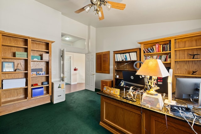 home office with dark colored carpet, ceiling fan, and vaulted ceiling