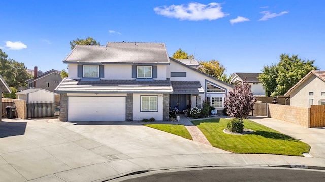 view of property featuring a garage and a front yard