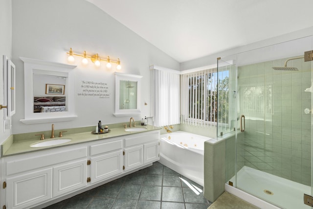 bathroom featuring tile patterned floors, vanity, independent shower and bath, and vaulted ceiling