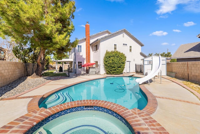 view of swimming pool with an in ground hot tub, a patio area, and a water slide