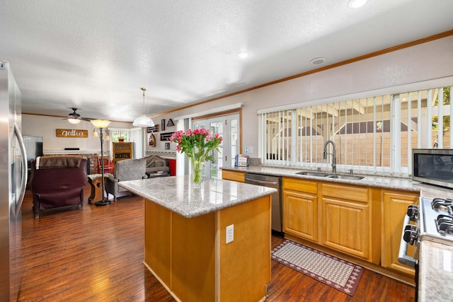 kitchen featuring light stone countertops, sink, dark wood-type flooring, a kitchen island, and appliances with stainless steel finishes