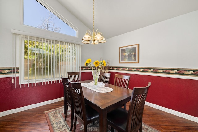 dining room with a notable chandelier, dark wood-type flooring, and high vaulted ceiling