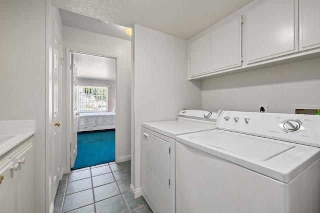 laundry room featuring cabinets and washing machine and clothes dryer