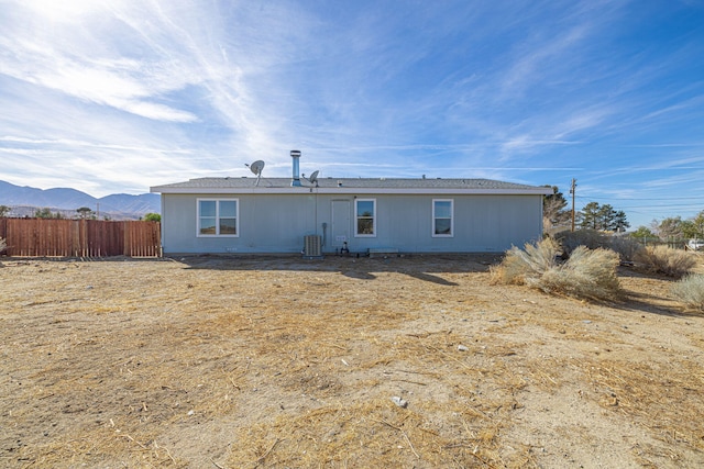 back of house featuring central AC and a mountain view