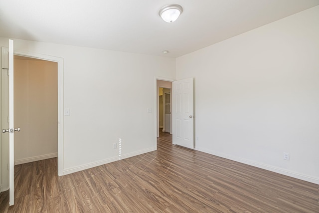 spare room with dark wood-type flooring