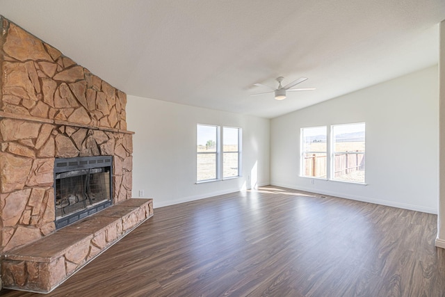 unfurnished living room with ceiling fan, lofted ceiling, dark hardwood / wood-style floors, and a fireplace