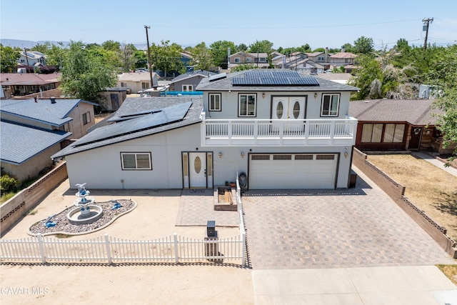 45503 Lorimer Ave, Lancaster, CA 93534 - view of front of house with driveway, solar panels, a garage, a residential view, and a balcony