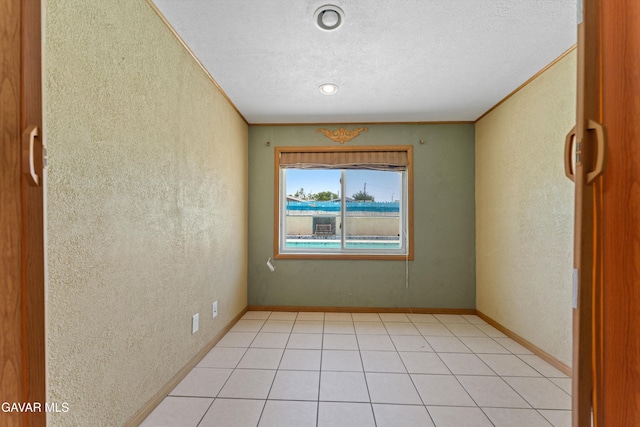 45503 Lorimer Ave, Lancaster, CA 93534 - empty room featuring a textured wall, a textured ceiling, and light tile patterned flooring