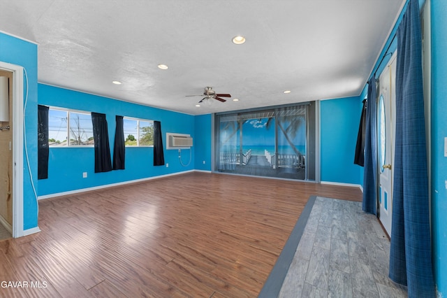 45503 Lorimer Ave, Lancaster, CA 93534 - unfurnished room with wood finished floors, a wall mounted air conditioner, recessed lighting, and ceiling fan