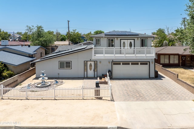 45503 Lorimer Ave, Lancaster, CA 93534 - front facade with solar panels, driveway, french doors, a balcony, and an attached garage