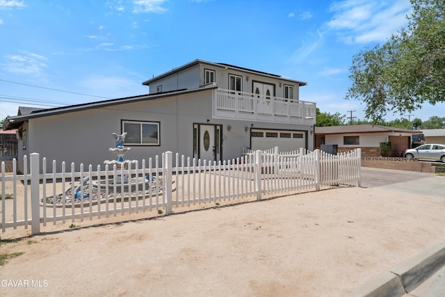 45503 Lorimer Ave, Lancaster, CA 93534 - view of front of home with concrete driveway, a balcony, a garage, and a fenced front yard
