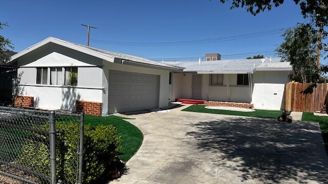 45526 Leatherwood Ave, Lancaster, CA 93534 - ranch-style home featuring a garage, driveway, and stucco siding