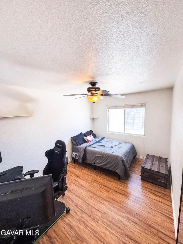 2895 59th St, Rosamond, CA 93560 - bedroom featuring wood finished floors, a desk, a textured ceiling, and ceiling fan