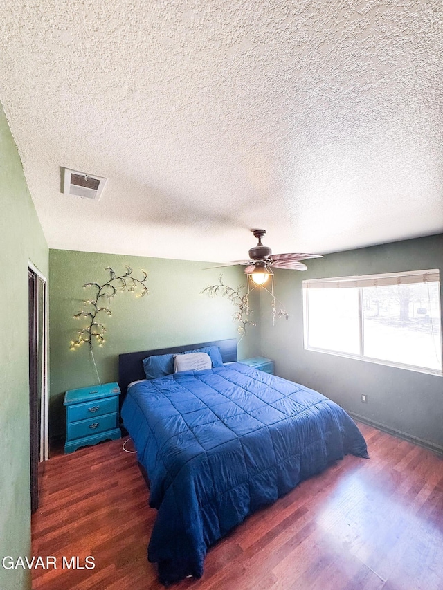2895 59th St, Rosamond, CA 93560 - bedroom with wood finished floors, a textured ceiling, ceiling fan, and a closet