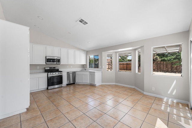 kitchen with a sink, light tile patterned flooring, visible vents, light countertops, and appliances with stainless steel finishes