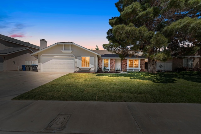 single story home with driveway, entry steps, a front yard, an attached garage, and brick siding