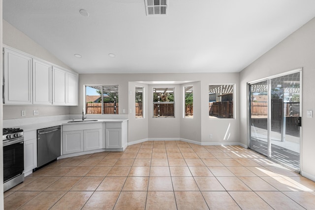 kitchen featuring lofted ceiling, white cabinetry, appliances with stainless steel finishes, visible vents, and light countertops