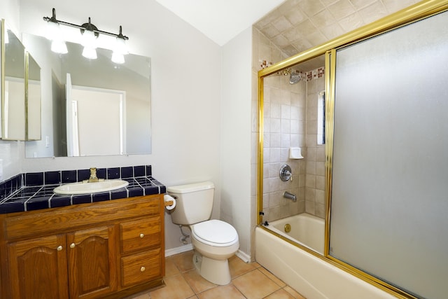 43334 W 32nd St Unit 12, Lancaster, CA 93536 - bathroom featuring toilet, tile patterned flooring, vanity, combined bath / shower with glass door, and vaulted ceiling