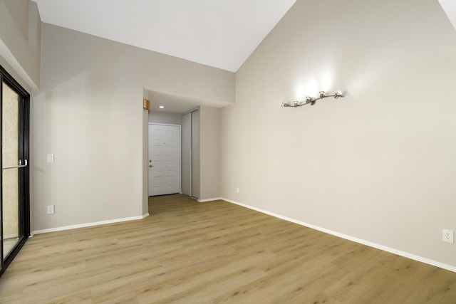 43334 W 32nd St Unit 12, Lancaster, CA 93536 - unfurnished room featuring vaulted ceiling, light wood-style floors, and baseboards