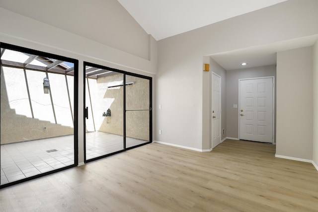 43334 W 32nd St Unit 12, Lancaster, CA 93536 - unfurnished room featuring wood finished floors, baseboards, and high vaulted ceiling