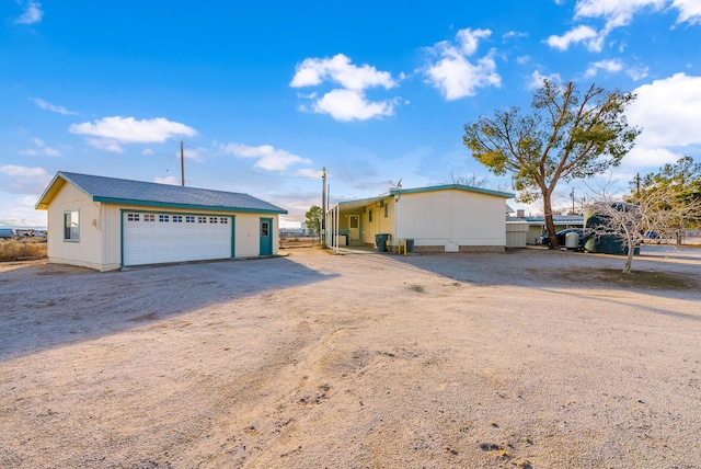 exterior space featuring an outbuilding and a garage