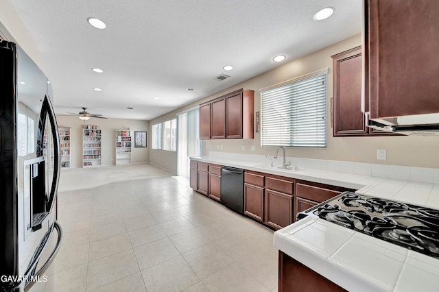 2354 Crimson Ave, Rosamond, CA 93560 - kitchen featuring stainless steel refrigerator with ice dispenser, dishwasher, tile counters, gas range oven, and open floor plan