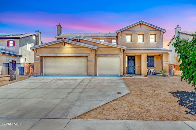 2354 Crimson Ave, Rosamond, CA 93560 - view of front of house featuring driveway, a garage, stucco siding, and covered porch