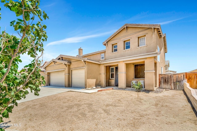 2354 Crimson Ave, Rosamond, CA 93560 - view of front of house with stucco siding, an attached garage, concrete driveway, and a chimney