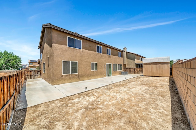 2354 Crimson Ave, Rosamond, CA 93560 - back of property featuring a patio area, a shed, a fenced backyard, and stucco siding