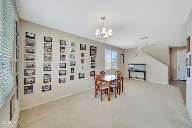 2354 Crimson Ave, Rosamond, CA 93560 - dining area featuring a chandelier and light carpet