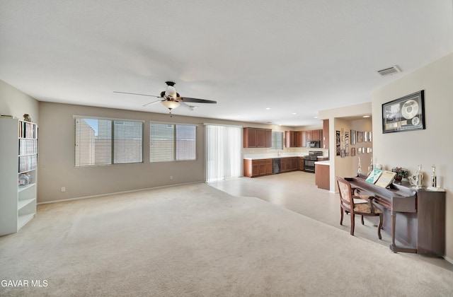 2354 Crimson Ave, Rosamond, CA 93560 - living area featuring plenty of natural light, ceiling fan, light colored carpet, and recessed lighting
