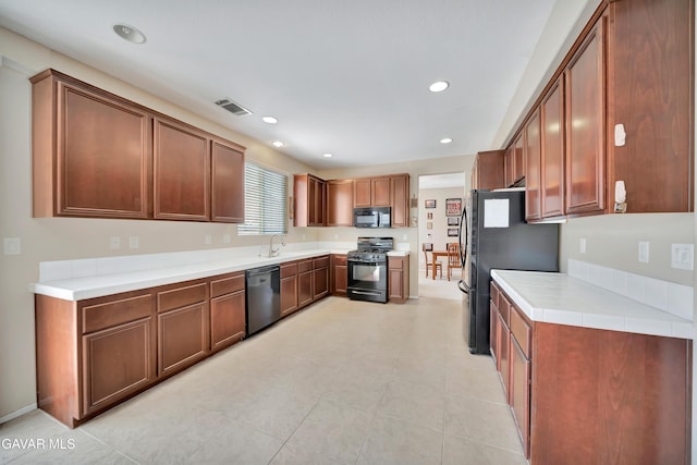2354 Crimson Ave, Rosamond, CA 93560 - kitchen with black appliances, light countertops, brown cabinets, and recessed lighting