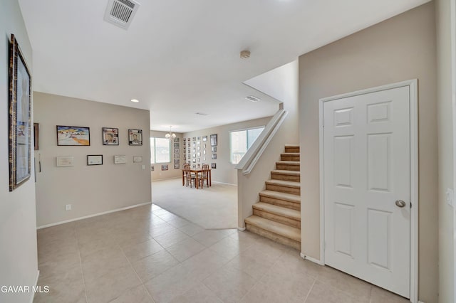 2354 Crimson Ave, Rosamond, CA 93560 - entryway featuring stairs, a chandelier, recessed lighting, light colored carpet, and light tile patterned floors