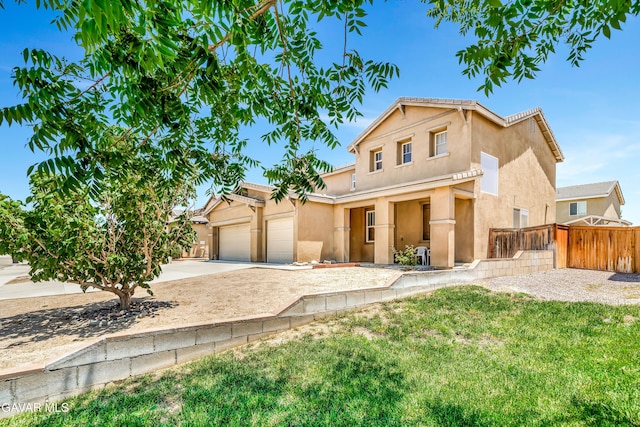 2354 Crimson Ave, Rosamond, CA 93560 - traditional home featuring stucco siding, driveway, and a garage