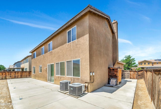 2354 Crimson Ave, Rosamond, CA 93560 - back of house featuring a patio, stucco siding, a fenced backyard, and a chimney