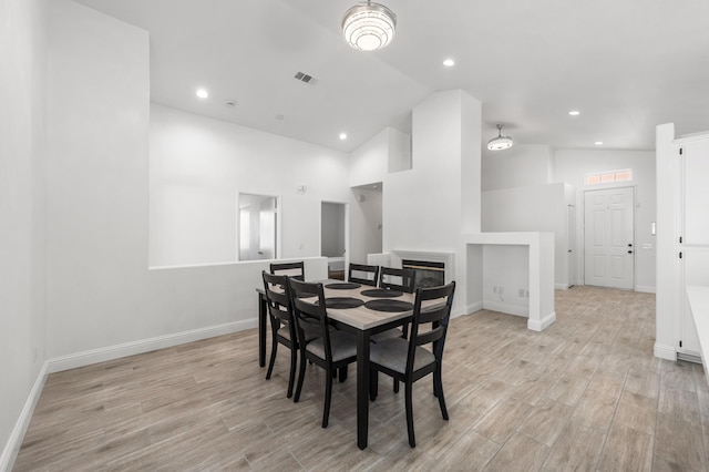 37116 Alder St, Palmdale, CA 93552 - dining room with light wood finished floors, baseboards, high vaulted ceiling, a glass covered fireplace, and recessed lighting