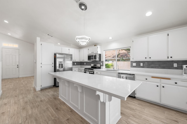 37116 Alder St, Palmdale, CA 93552 - kitchen featuring stainless steel appliances, decorative backsplash, white cabinetry, light countertops, and a sink