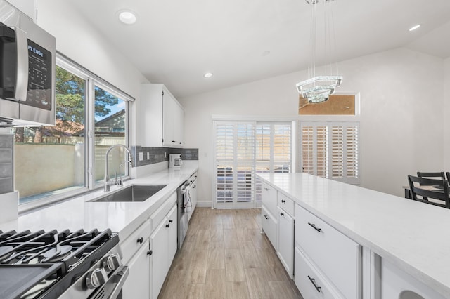 37116 Alder St, Palmdale, CA 93552 - kitchen featuring appliances with stainless steel finishes, lofted ceiling, a sink, tasteful backsplash, and light countertops